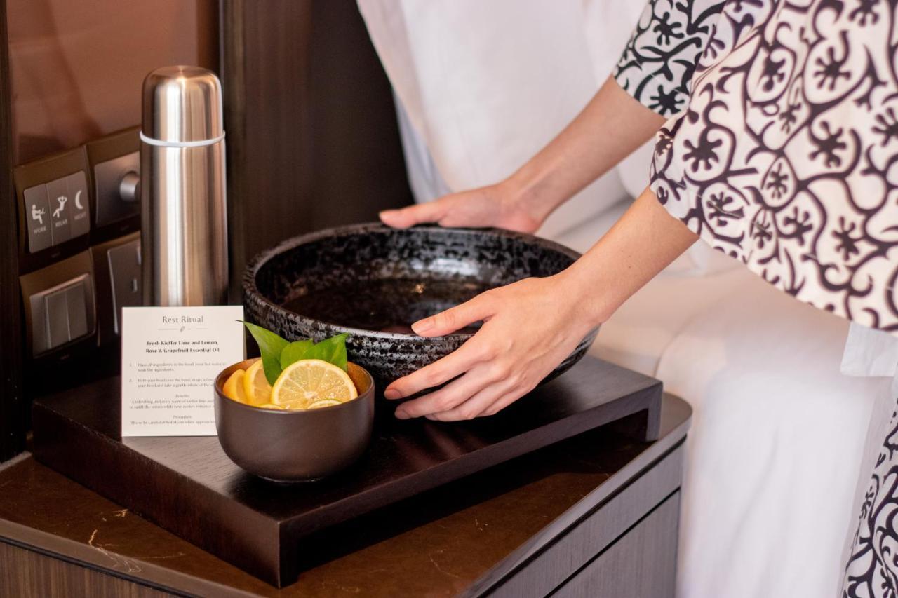 Banyan Tree Kuala Lumpur Hotel Exterior photo A spa attendant prepares a bowl of spa mud for a spa treatment